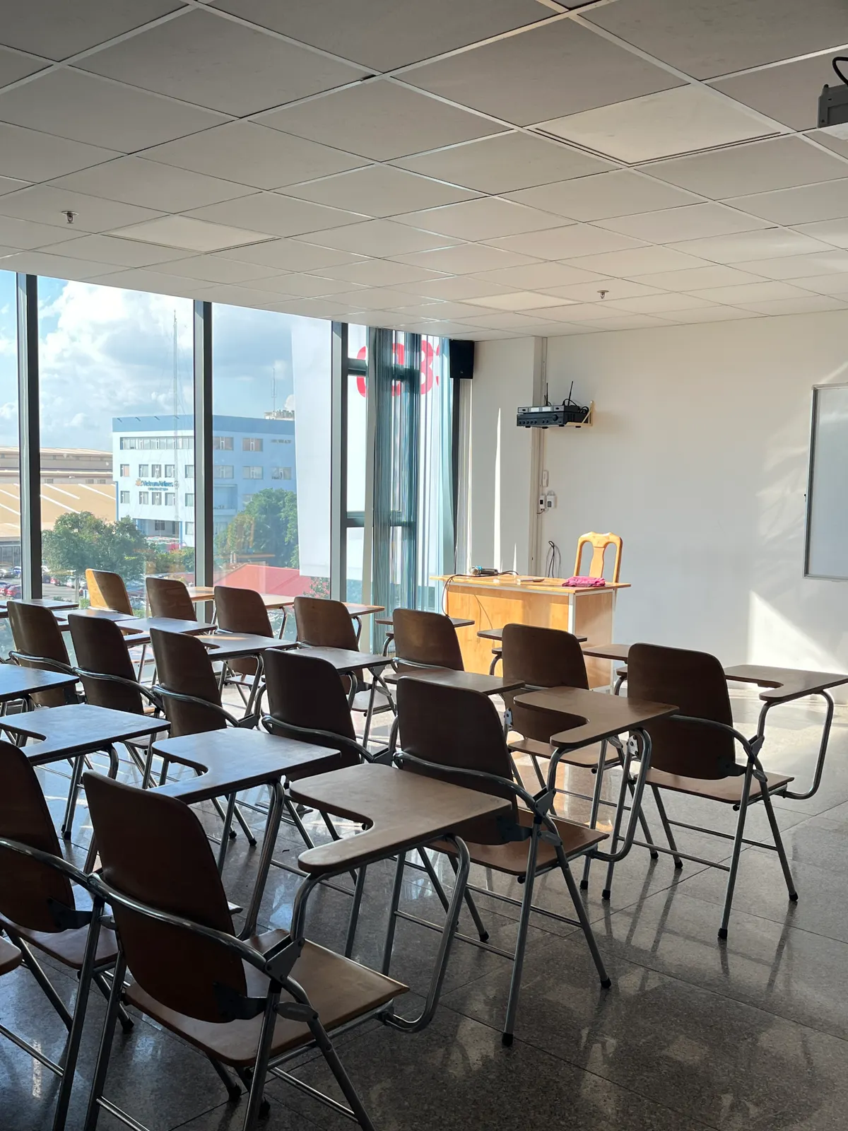 Sample image: Wooden desks in a classroom with sunlight through the windows