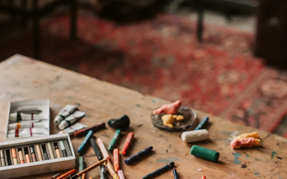 Sample image: Crayons and colouring materials spread on a wooden table